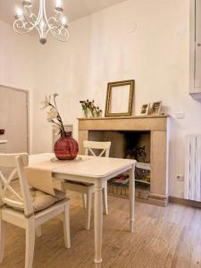 a living room with a table and a fireplace at Palazzo Monterone Apartments in Spoleto