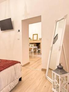 a bedroom with a mirror and a bed and a table at Palazzo Monterone Apartments in Spoleto