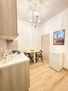 a kitchen with a stove and a table in it at Palazzo Monterone Apartments in Spoleto +19 photos