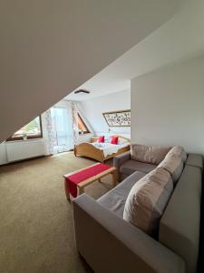 a living room with a couch and a bed at Hotel Beskidian in Węgierska Górka +106 photos