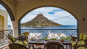 a room with a view of the ocean from a balcony at Casa Sabine in Masouri