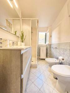 a bathroom with a toilet and a sink and a tub at Palazzo Monterone Apartments in Spoleto