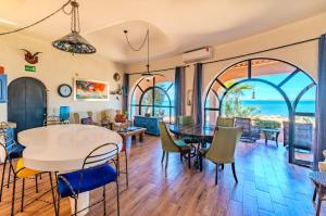 a dining room and living room with a table and chairs at Casa Kootenay Waterfront Bnb in La Paz