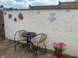 a table and two chairs in front of a wall at 13 Chute Street central and homely in Exeter