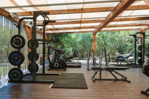 a gym with several treadmills and exercise machines at La Villa Del Re - Adults Only - Small Luxury Hotels of the World in Castiadas