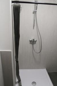 a shower with a black shower curtain in a bathroom at My Pension City Großaitingen - Augsburg in Großaitingen +49 photos