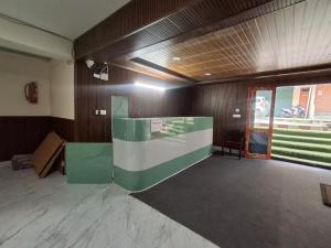 a large room with a green and white wall at LHO-Men RESIDENCY in Gangtok