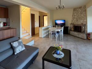 a living room with a couch and a table at Villa Beauty in Paliouri