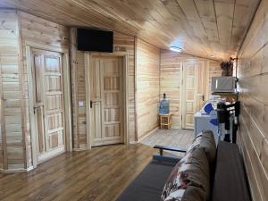 a room with wooden walls and a tv on the wall at Welcome to Карпати in Skole