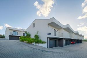 a white building on a brick road at Vinyl M Hotel Design Inn in Mealhada