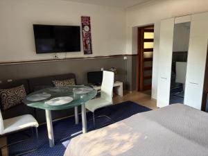 a room with a table and chairs and a bed at Újszeged apartman in Szeged
