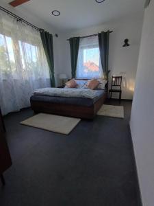 a bedroom with a large bed with curtains and rugs at Gawędówka in Czchów