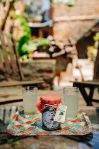 a jar of soy sauce on a table with two glasses at Clio apartments in Kambos +48 photos