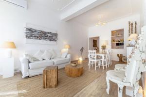 a living room with a white couch and a table at Piazza di Spagna Historic Flat in Rome