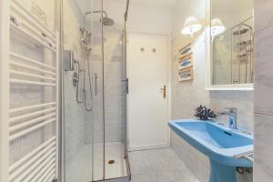 a bathroom with a shower and a blue sink at Piazza di Spagna Historic Flat in Rome +33 photos