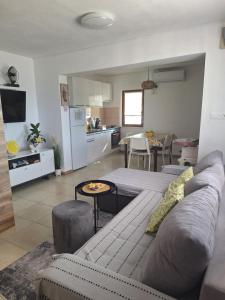 a living room with a couch and a kitchen at 4 you in Nin