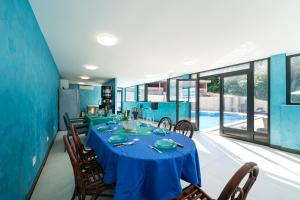 a dining room with a blue table and chairs at Apartments Rajsko Mjesto in Tivat +57 photos