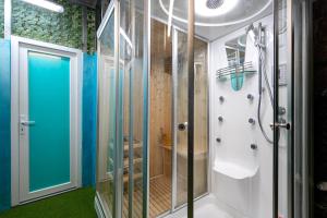 a bathroom with a shower and a glass door at Apartments Rajsko Mjesto in Tivat