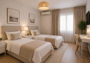 a hotel room with two beds and a table and a desk at Hostal Palma Hermosa in El Puerto de Santa María
