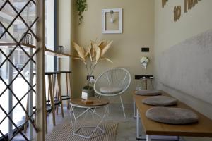 a living room with a staircase and a table and chairs at Chania Capsule Stay in Chania