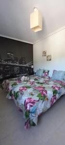 a bedroom with a large bed with a colorful blanket at Rincón de Candelaria in Solórzano