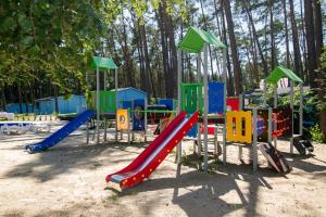 a playground with a slide in a park at Greckie Domki ZEUS in Stegna