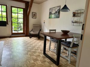 a living room with a wooden table and chairs at Tiny House mit Terrasse nahe dem Bodensee in Wahlwies +5 photos