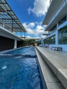 a swimming pool in the middle of a house at The Hermitage Tagaytay-Presidential Suite in Malabag