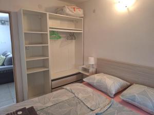 a small bedroom with a bed and a closet at 4 you in Nin