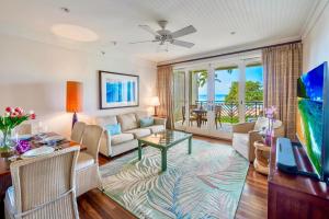 a living room with a couch and a table at Villa 202 at Turtle Bay in Kahuku