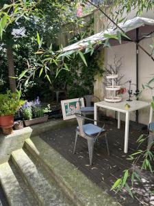a patio with a table and a chair in a garden at Loft Crimea con patio in Turin