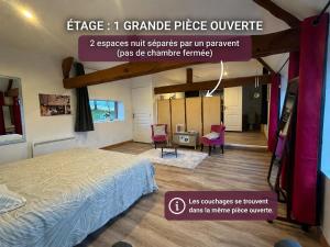 a room with a bed and two chairs in it at gite "La Renaudaie" - piscine in Juvigny-le-Tertre