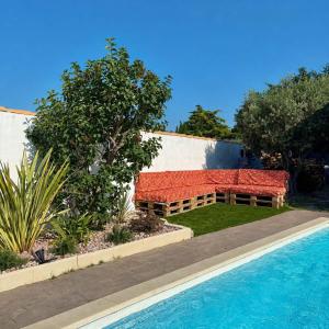 a house with a swimming pool and a red roof at Les Elles du Moulin Avec Piscine in Vedène
