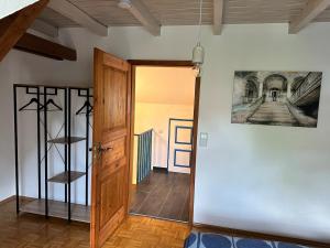 a hallway with a door and a painting on the wall at Tiny House mit Terrasse nahe dem Bodensee in Wahlwies