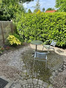 two chairs and a table and a table and chairs at Tiny House mit Terrasse nahe dem Bodensee in Wahlwies