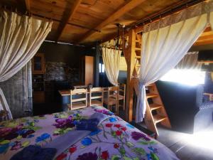 a bedroom with a bed and a table and chairs at Wagon Wheel Gabin in Chrissiesmeer