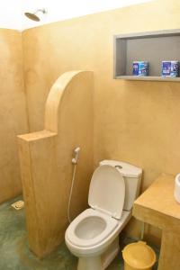 a small bathroom with a toilet and a sink at Bamboo Garden B&B in Kendwa +151 photos