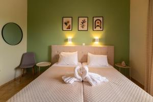 a bedroom with a bed with a towel on it at Tony studio & apartments in Laganas