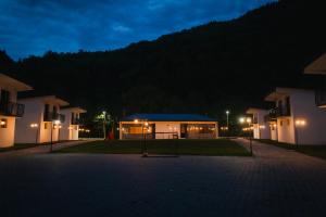 a night view of a building at night at Camping Colibita in Colibiţa