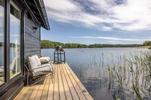 a dock on a house with a view of a lake at The Floating Lodge in Linköping