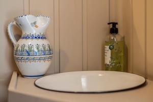 a vase sitting on a table next to a bottle of soap at The Floating Lodge in Linköping