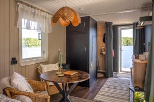 a living room with a table and a couch at The Floating Lodge in Linköping +14 photos