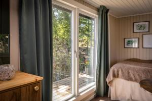a bedroom with a window with a view of a deck at The Floating Lodge in Linköping