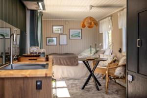 a kitchen and living room with a table and a couch at The Floating Lodge in Linköping