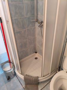 a shower in a bathroom with a toilet at Nicks house by zarkco in Artemida +10 photos