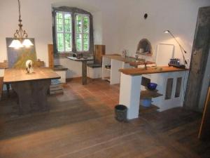 a kitchen with wooden counters and a table in a room at Schloss Höllrich in Karsbach