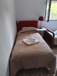 a bedroom with a bed with a towel on it at Nicks house by zarkco in Artemida