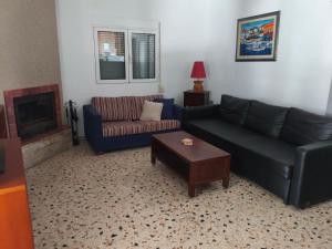a living room with two couches and a coffee table at Nicks house by zarkco in Artemida
