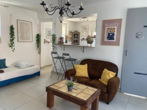 a living room with a couch and a coffee table at Le Pivoine in Gury