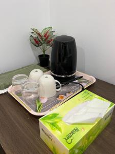 a table with a coffee maker and a box on it at Mickleham Prestige Homestay in Mickleham